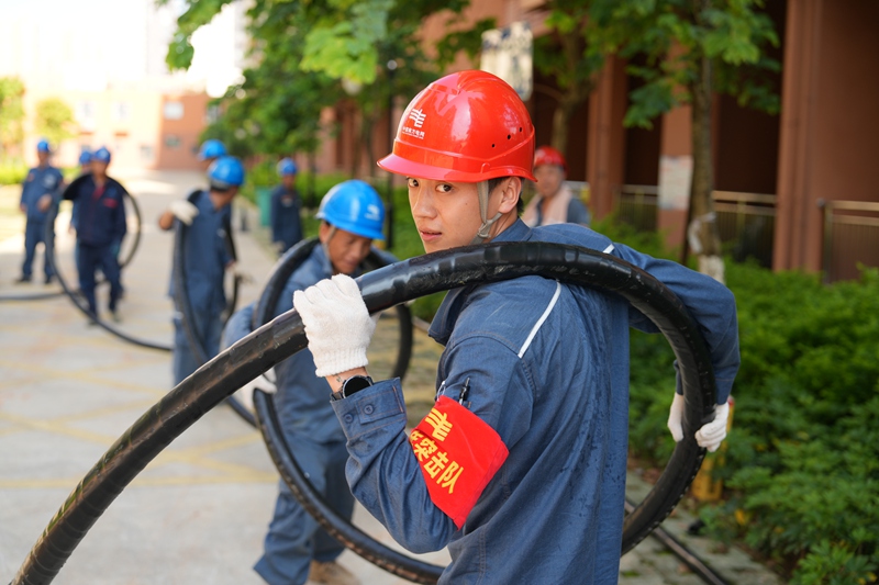 在廣西貴港市荷城麗園小區(qū)，南方電網(wǎng)貴州六盤水供電局搶修人員敷設(shè)高壓電纜。潘聰攝