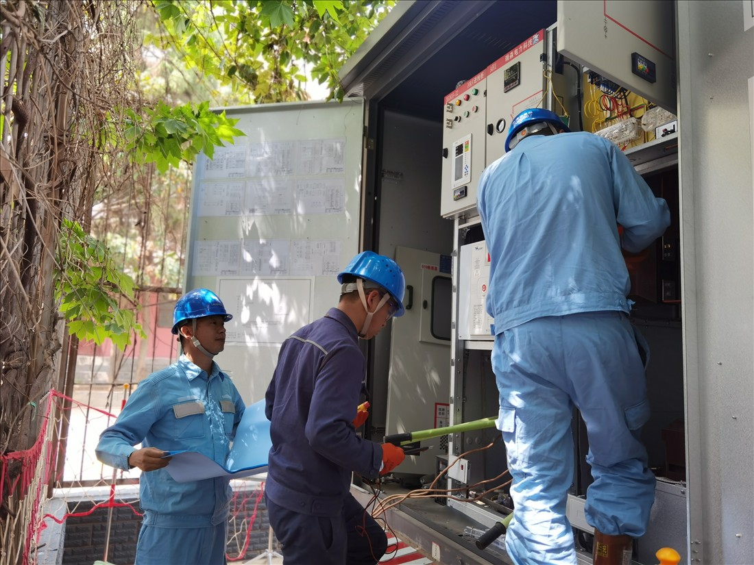 南方電網(wǎng)云南曲靖供電局工作人員對充電站計量表計封印前進行驗電。（阮松萍）.jpg